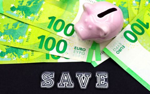 A piggy bank on euro bills with 'save' text highlights money saving concepts.