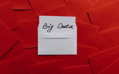 White envelope with 'Big Data' text on red envelope background. Conceptual digital imagery.