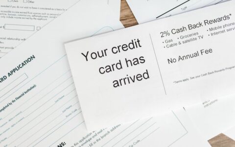 Close-up of a letter announcing the arrival of a credit card amidst financial documents.